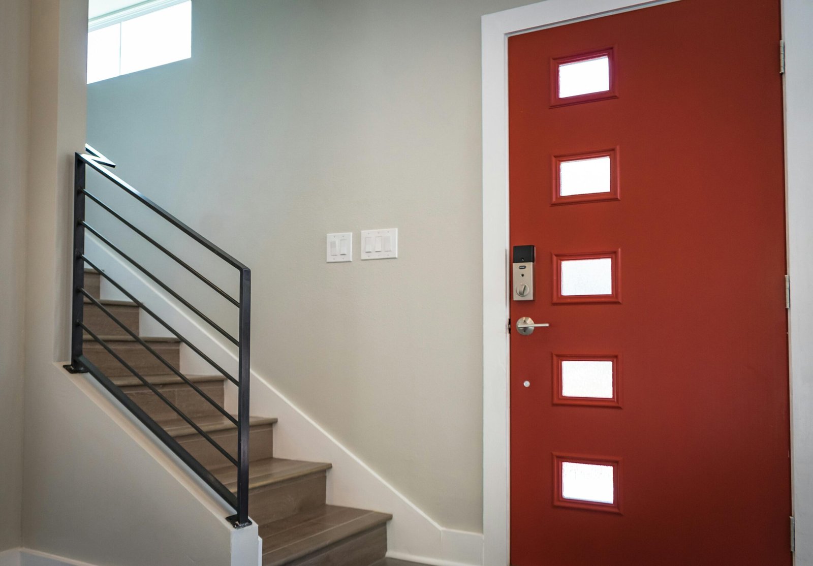 Red Wooden Door Beside Stairs